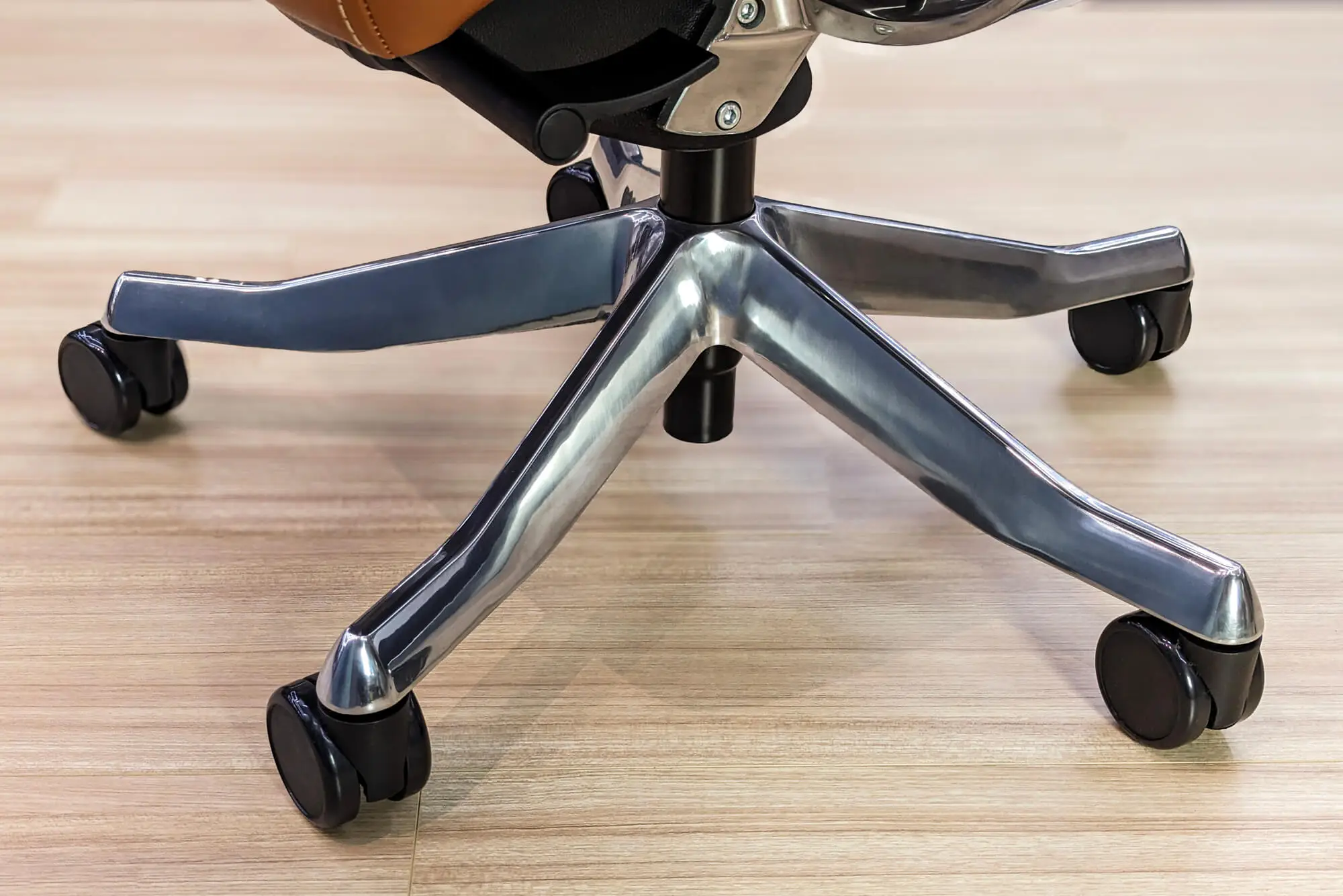 Five-point star base with smooth-rolling casters on an ergonomic office chair