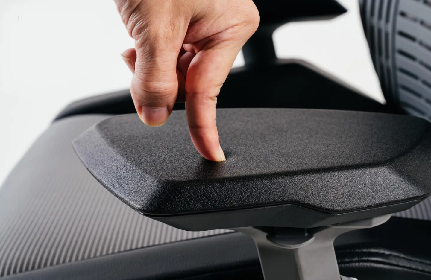Adjustable armrests on an ergonomic office chair supporting forearms and reducing wrist strain